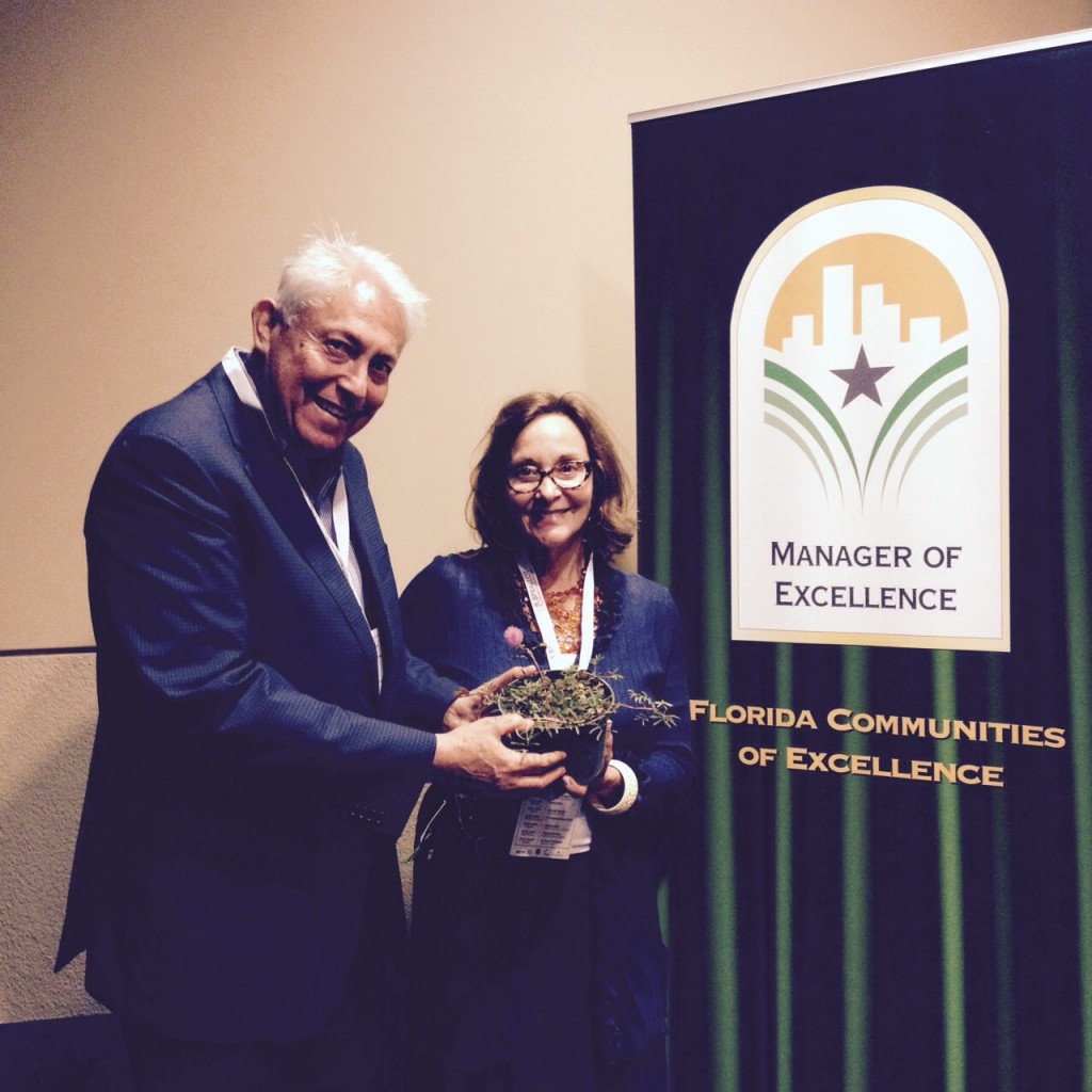 Event coordinators Alan and Ellen Penchansky, of the Pen Group, show off their Sunshine Mimosa plant.