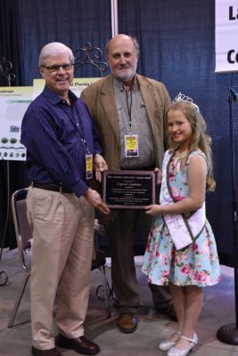 UF Landscape Architecture Professor Glenn Acomb accepts award from Miss Florida Wildflower Festival on behalf of Crystal Simmons