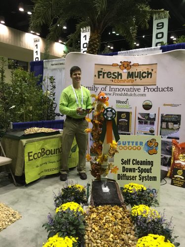 Fresh Mulch Company, makers of Weed Recede biodegradable mulch bags, Gutter Guppy & Guppy Tails and other ecofriendly products, on display. Standing here is owner Bob Hawkinson's son Chad, helping Dad help attendees "think beyond plastic."