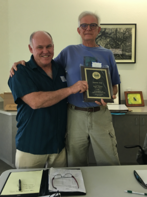 FANN President Bruce Turley presents Past President Roger Triplett with plaque commemorating his many years of board service.
